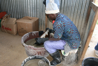This miner is using safe methods to ensure he does not directly handle mercury.